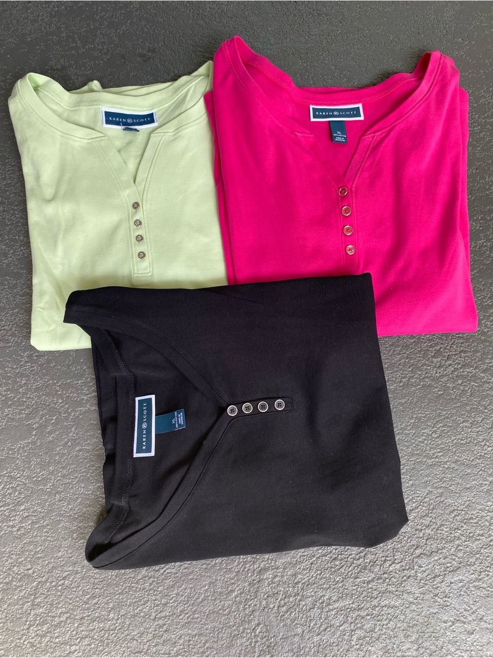 This is a black short-sleeve Henley t-shirt from Karen Scott featuring a four-bu